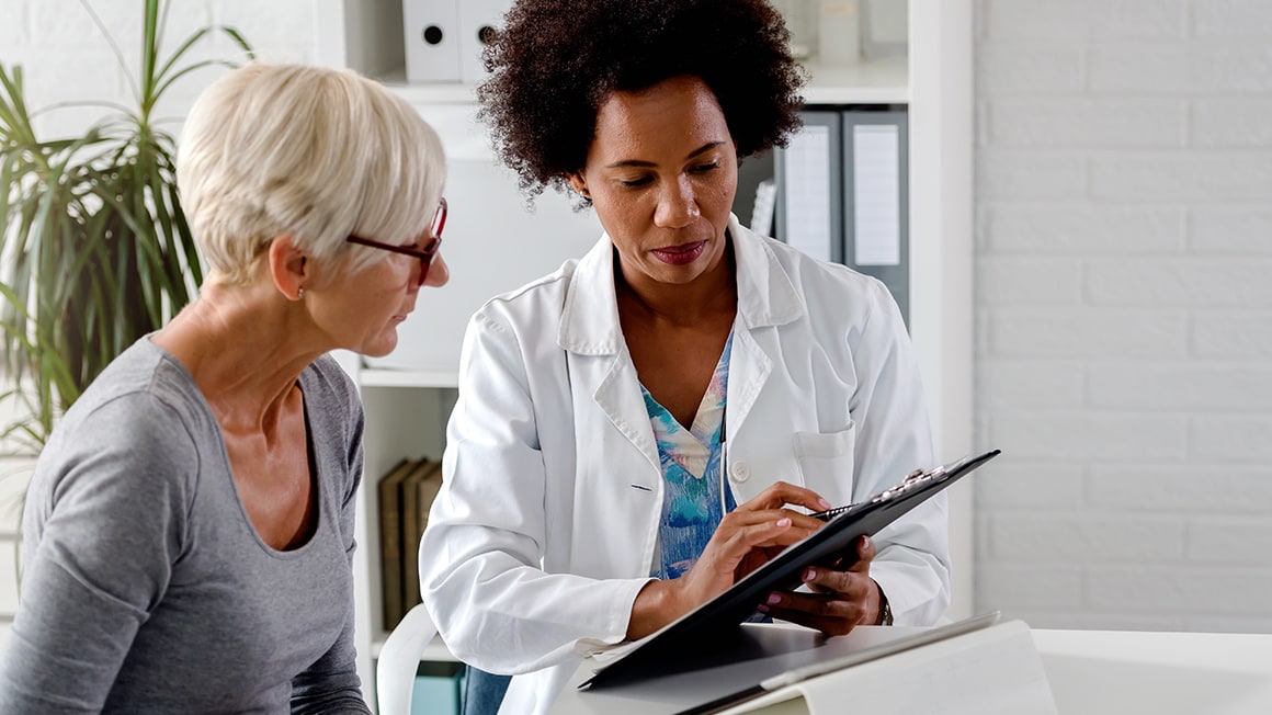 A doctor going through paperwork with a patient