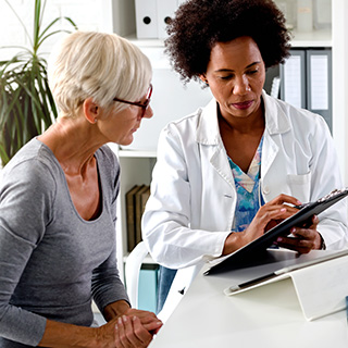 Doctor explaining chart to woman